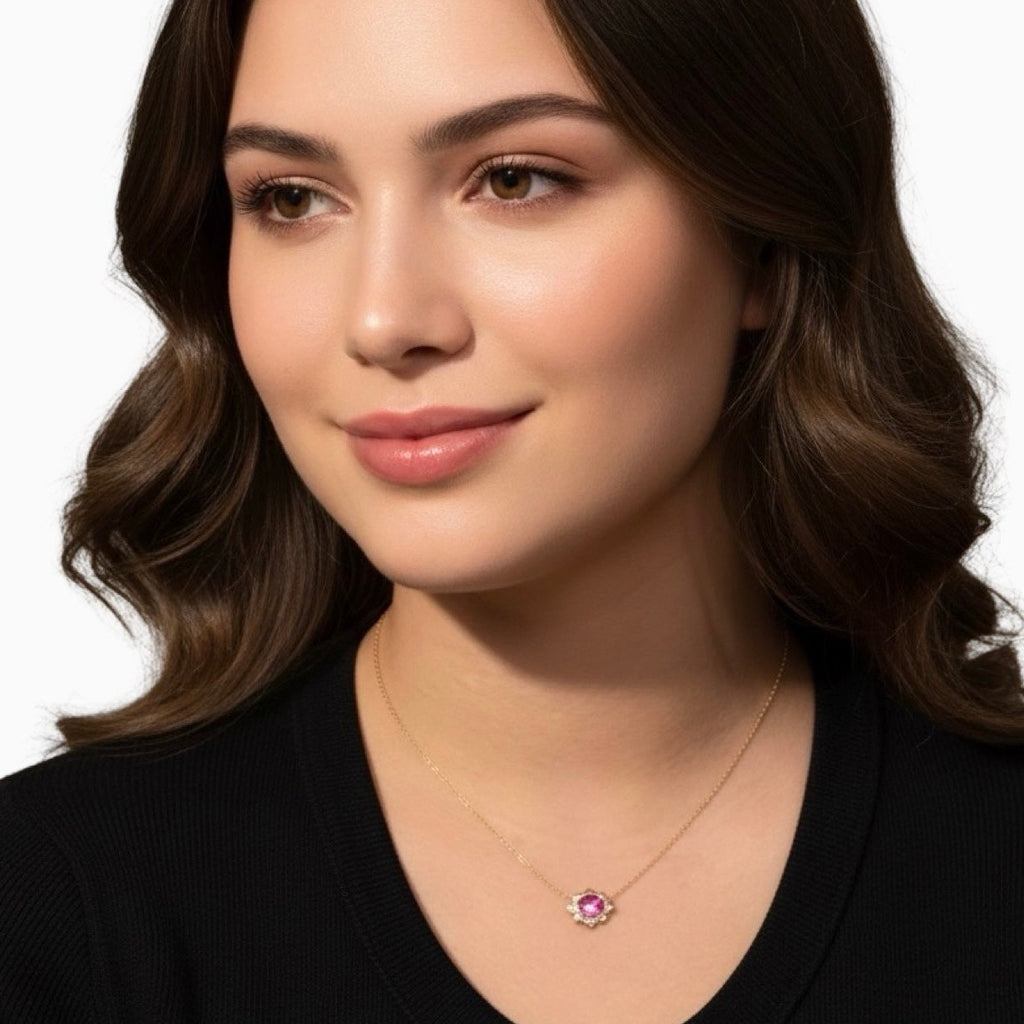 Woman wearing a necklace with a pink gemstone on a white background